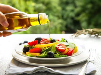 Pouring oil on salad