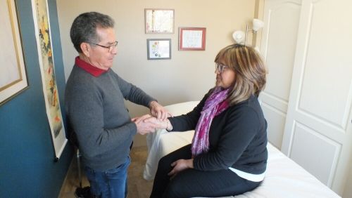 Juan working with patient in his clinic room.