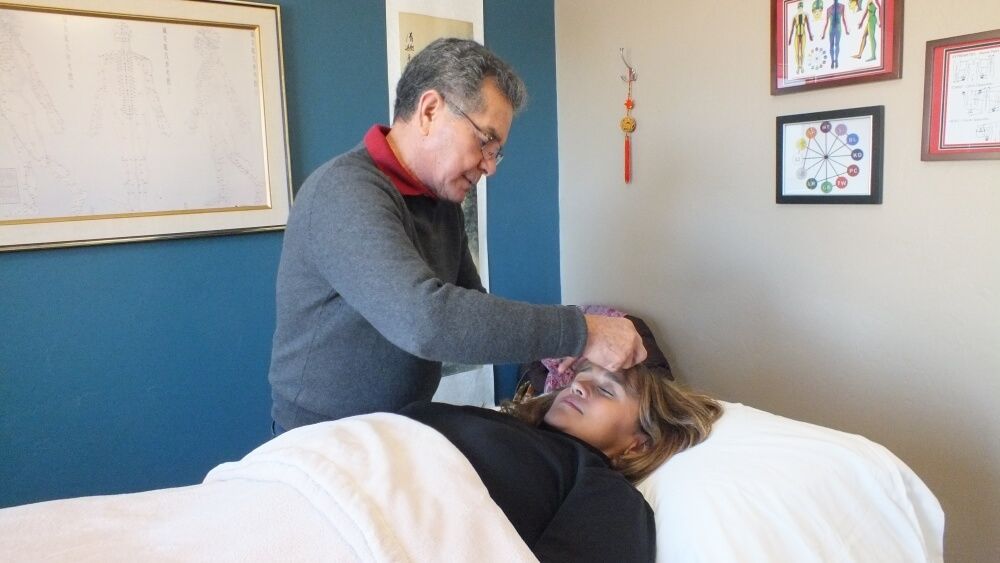 Juan Working with a patient in clinic room.