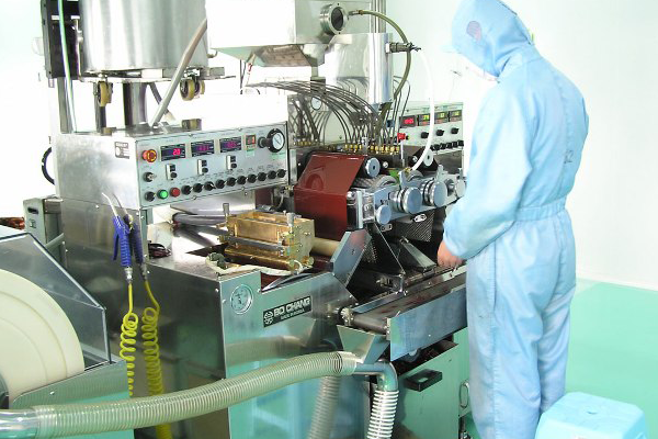 Man working in factory making pills