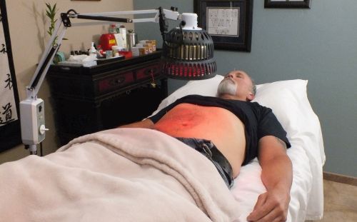 Patient in Juans clinic laying on a patient bed.