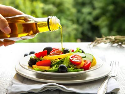 Pouring oil on salad